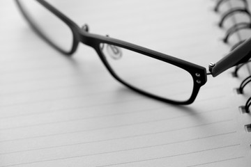 close up glasses on blank paper 