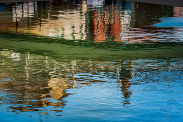 Colorful houses reflection in a sea in Italy
