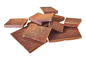 Lot of pieces of broken bar dark bitter or milky chocolate sprinkled of powder cocoa isolated on...