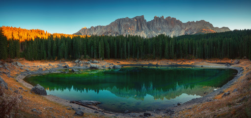 Carezza lake in Dolomitesn  or Lago di Carezza with reflection of mountains at sunset in the...