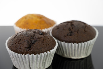 Delicious of banana and chocolate chip cupcake isolated on black background
