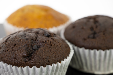 Delicious of banana and chocolate chip cupcake isolated on black background