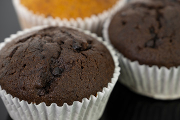 Delicious of banana and chocolate chip cupcake isolated on black background