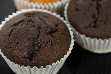 Delicious of banana and chocolate chip cupcake isolated on black background