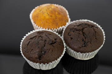 Delicious of banana and chocolate chip cupcake isolated on black background