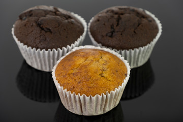 Delicious of banana and chocolate chip cupcake isolated on black background