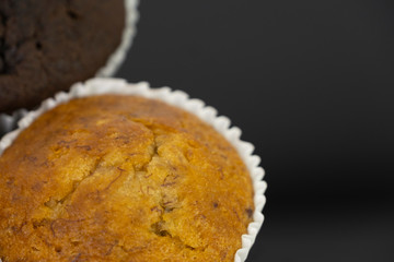 Delicious of banana and chocolate chip cupcake isolated on black background