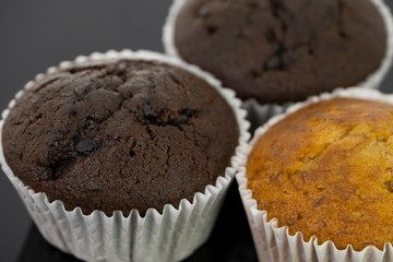 Delicious of banana and chocolate chip cupcake isolated on black background