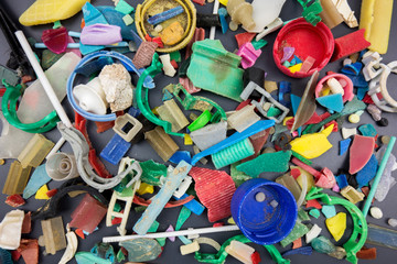 Microplastics collected on the beach. Plastic pollution concept.