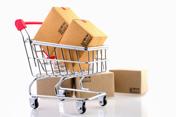 Paper boxes in a trolley on white background. Ideas online shopping is a form of electronic commerce that allows consumers to directly buy goods from a seller over the internet.