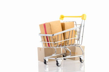 Paper boxes in a trolley on white background. Ideas online shopping is a form of electronic commerce that allows consumers to directly buy goods from a seller over the internet.