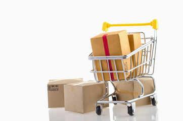 Paper boxes in a trolley on white background. Ideas online shopping is a form of electronic commerce that allows consumers to directly buy goods from a seller over the internet.