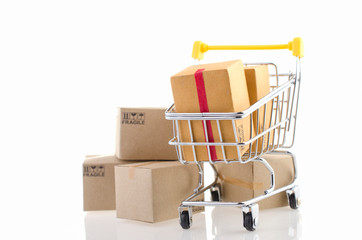Paper boxes in a trolley on white background. Ideas online shopping is a form of electronic commerce that allows consumers to directly buy goods from a seller over the internet.