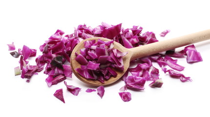 Chopped up, sliced and diced red, purple cabbage with wooden spoon isolated on white background