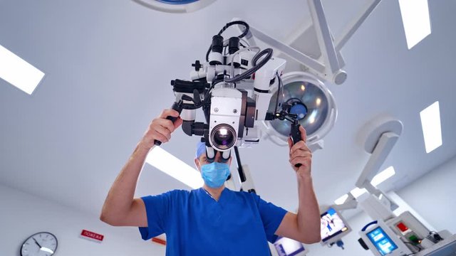 Surgeon operating with medical robotic surgery machine. Manual control by Minimally Invasive Surgical System. Modern automated medical device.