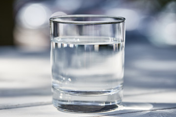 fresh clean water in transparent glass at sunny day outside