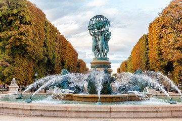 Beautiful autumn park with a fountain in Paris. Space for text. Postcard.