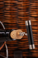 Opening a wine bottle with a cork screw in a restaurant