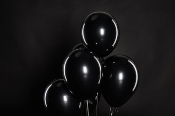 bunch of black balloons isolated on balck, black Friday concept