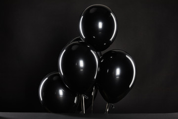 bunch of black balloons isolated on black, black Friday concept
