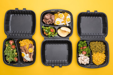 top view of eco packages with apples, vegetables, meat, fried eggs and salads isolated on yellow