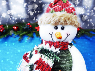 christmas snowman on fir tree branch with cones and snow on background