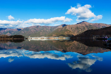 landscape river reflection view of bridge, mountain and traffic under blue sky, nature background