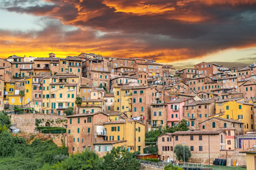Fototapeta premium Sunset over colorful buildings in Siena Italy