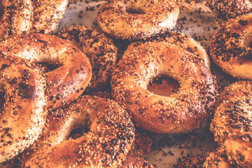 Authentic New York style freshly baked bagels sprinkled with black sesame and poppy seeds.