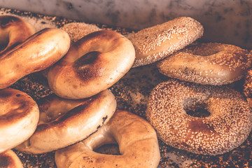 Authentic New York style freshly baked bagels sprinkled with black sesame and poppy seeds.