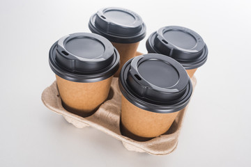 paper cups with coffee in cardboard tray on white background