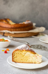 Open pie with cottage cheese filling on a wooden cutting board with milk. Healthy children breakfast or snack.