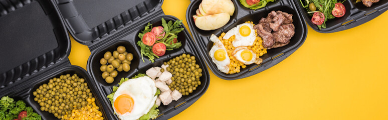 panoramic shot of eco packages with apples, vegetables, meat, fried eggs and salads isolated on yellow