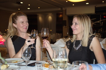 Portrait of mature women having toast in restaurant