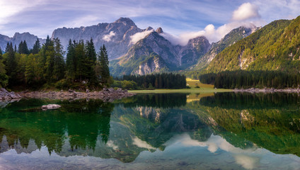 magnificent landscape which consists of a panorama of mountain lake and mountains reflecting in a mirror of water of the lake
