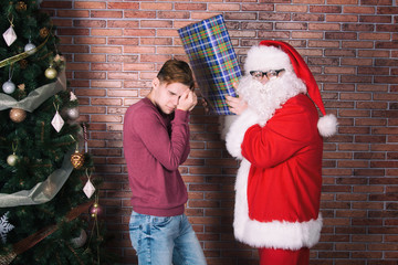 Christmas and New Year. Funny guy and Santa Claus.