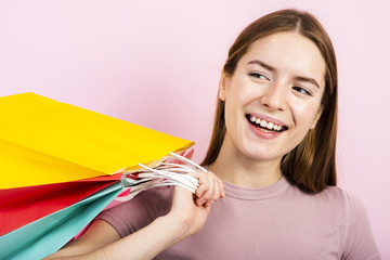 Close-up smiling woman holding bags