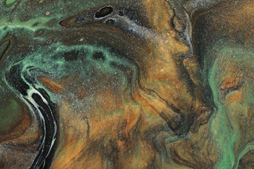Earth tones of brown, green, black, white, shimmery silver, and glittering gold combine to form this flowing and organic abstract background.