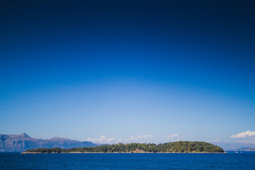 sea and blue sky and a tiny iclend