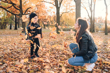 Happy mother and son in autumn city park