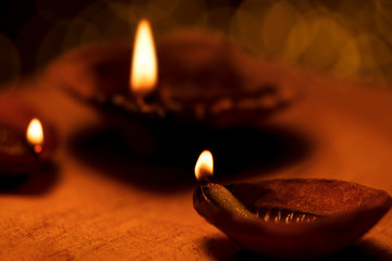 Diwali Diya Background. Traditional Diwali Oil lamps or diya lit on the occasion of diwali festival...