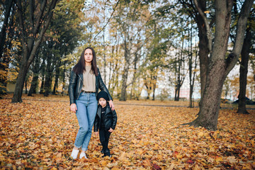 Happy mother and son in autumn city park