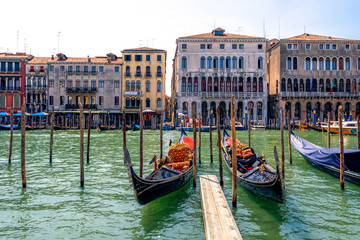 Fototapeta na wymiar Gondolas docked at departure point near Rialto Bridge, Venice, Italy