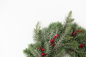 winter holidays, new year and decorations concept - wreath of fir branches with red berries on...