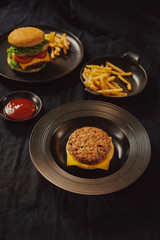 Fresh Tasty burger on dish with with french fries, ketchup