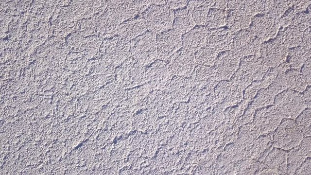 Aerial top down of hexagonal patterns of salt in Uyuni salt flat floor. DOLLY OUT