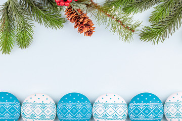 Copy space in happy New Year decorations - ball toys with ornament and Christmas tree branches with cone. Concept of Xmas letter with congratulations. Top view.