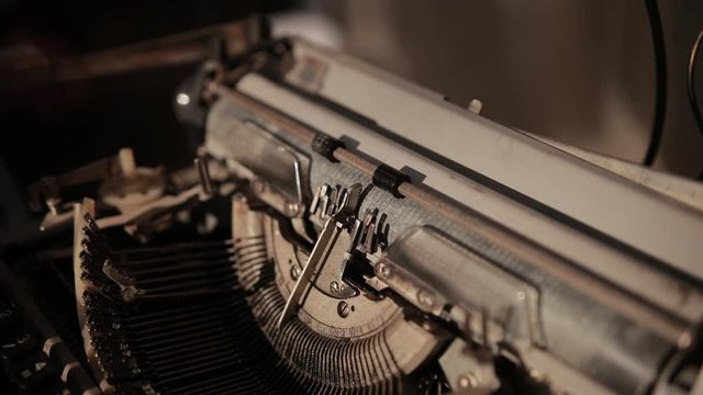 close-up of process of ancient printing machine, man in white gloves presses keyboard, slow motion
