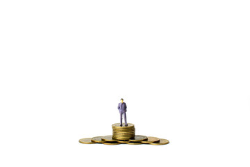 Obraz na płótnie Canvas Miniature figures businessman on coins, on the white backgroud.