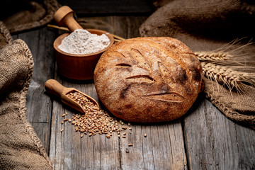 Freshly baked traditional bread on wooden table